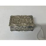A SILVER SNUFF BOX OF RECTANGULAR FORM WITH HEAVILY EMBOSSED DECORATION THROUGHOUT, HALLMARKED