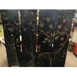 A BLACK ORIENTAL FOUR FOLD SCREEN DECORATED WITH BIRDS INTHE TREES A/F