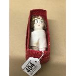 A 19TH CENTURY CERAMIC DOLL, IN WICKER LIKE BOX, 12CM HIGH