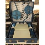 A VINTAGE BLUE PICNIC SET BY SIRRAM, INCLUDING DRINKS FLASKS, PLATES, CUTLERY AND MORE