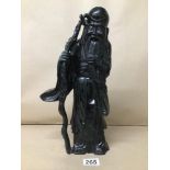 A HEAVY ORIENTAL CARVED STONE FIGURE OF AN ELDERLY WISE MAN HOLDING A STICK, 36.5CM HIGH