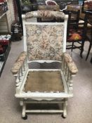 A PAINTED AMERICAN ROCKING CHAIR IN NEED OF A CUSHION