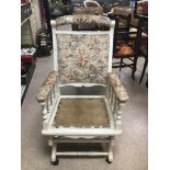 A PAINTED AMERICAN ROCKING CHAIR IN NEED OF A CUSHION