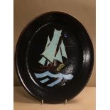 A POOLE POTTERY AEGEAN PLATTER OF OVAL FORM DEPICTING A SAILING BOAT AT SEA, DECORATED ON A BROWN