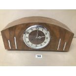 A MID CENTURY WOODEN CASED GERMAN MANTLE CLOCK WITH ART DECO STYLING, RAISED UPON FOUR BUN FEET