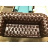 A BROWN BUTTON BACK LEATHER CHESTERFIELD THREE SEATER SOFA