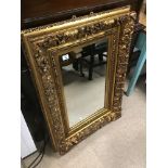 A HEAVY ORNATE GILDED MIRROR 73 X 101CMS