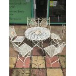 AN ORNATE FOLDING METAL GARDEN TABLE WITH CHAIRS
