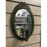 A BRASS WALL MIRROR WITH SINGLE ARM CANDLE WALL SCONCE, 35CM HIGH