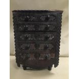 A LATE 19TH/EARLY 20TH CENTURY CARVED OAK CHEST OF TABLETOP DRAWERS, HIGHLY DECORATED THROUGHOUT