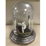 A VICTORIAN WAXWORK DOLL OF A BABY, MOUNTED ON A SILVER PLATED BASE WITH GLASS DOME, THE DOLL WITH