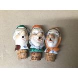 A GROUP OF THREE NOVELTY PORCELAIN WINE BOTTLE POURER STOPPERS IN THE FOR OF PEOPLE
