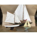 THREE PAINTED MODEL YACHTS OF VARYING SIZES, LARGEST 63CM HIGH