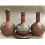 THREE TERRACOTTA POTS OF VARYING SIZES AND A PLATE