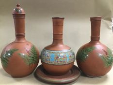 THREE TERRACOTTA POTS OF VARYING SIZES AND A PLATE