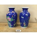 A PAIR OF JAPANESE PORCELAIN VASES, EACH DEPICTING A PEACOCK RESTING IN A TREE, 18.5CM HIGH