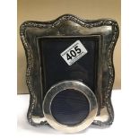 TWO SILVER MOUNTED PHOTO FRAMES, ONE RECTANGULAR, THE OTHER CIRCULAR