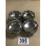 A SET OF FOUR LATE VICTORIAN EMBOSSED SILVER SALTS OF CIRCULAR FORM, RAISED UPON HOOF FEET,