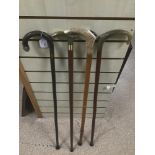 FOUR WALKING STICKS, ONE WITH A SILVER MOUNT, ANOTHER A HORN HANDLED WHISTLE, BRASS HANDLE AND