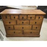 A THIRTEEN DRAWER PINE CHEST