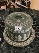 A VICTORIAN WEDGEWOOD GREEN JASPERWARE CHEESE DISH AND COVER DECORATED IN CLASSICAL FIGURES