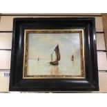 AN EBONISED FRAMED OIL ON BOARD SIGNED M.M OF FISHING BOATS AT SEA 37 X 32CMS