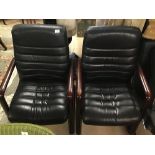 A PAIR OF BLACK LEATHER STYLE ARMCHAIRS