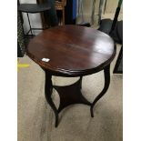 A MAHOGANY ROUND TWO TIER TABLE ON TURNED OUT LEGS