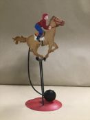 A NOVELTY METAL ROCKING RACING HORSE TOY
