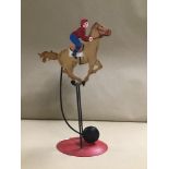 A NOVELTY METAL ROCKING RACING HORSE TOY