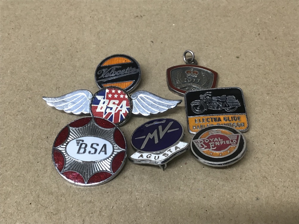 SIX VINTAGE ENAMEL MOTORCYCLE BADGES, INCLUDING BSA, MV AGUSTA, ROYAL ENFIELD AND HARLEY DAVIDSON,