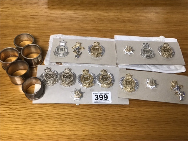 A COLLECTION OF ASSORTED MILITARY CAP BADGES FROM VARIOUS REGIMENTS WITH NAPKIN RINGS