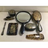 A FAUX TORTOISESHELL DRESSING TABLE SET WITH ENGRAVED GILT DRAGON DECORATION, INCLUDING HAND MIRROR,