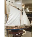 A MASTED POND YACHT RAISED UPON STAND, 84CM HIGH