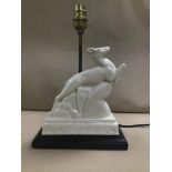 AN ART DECO STYLE FIGURAL TABLE LAMP DEPICTING A LEAPING DEER
