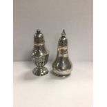 TWO SILVER PEPPER POTS OF BALUSTER FORM, THE EARLIEST BEING VICTORIAN AND HALLMARKED BIRMINGHAM 1897