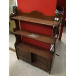 A VINTAGE SHELF UNIT THREE TIER WITH A BOTTOM CUPBOARD