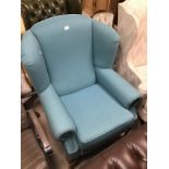 A VINTAGE BLUE WINGBACK ARMCHAIR