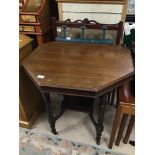 A MAHOGANY HEXAGONAL TWO TIER TABLE ON ORIGINAL CASTORS