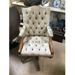 A LEATHER SWIVEL GAINSBOROUGH ARMCHAIR