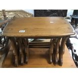 AN ERCOL NEST OF THREE TABLES WITH ORIGINAL LABELS TO UNDERSIDE, LARGEST 57CM WIDE