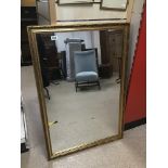 A LARGE GILT FRAMED WALL MIRROR OF RECTANGULAR FORM, 100CM WIDE