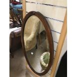 A VINTAGE BEVELLED EDGE MIRROR OVAL SHAPE WITH DECORATIVE INLAY 93 X 50CMS