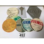 A CHROME AA CAR BADGE, V93894, TOGETHER WITH AN AA KEY AND A GROUP OF VINTAGE TAX DISKS, EARLIEST