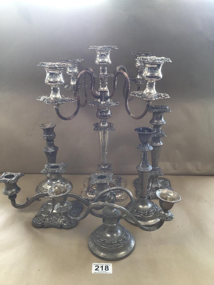 A GROUP OF SILVER PLATED CANDELABRAS AND CANDLESTICKS