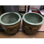 A PAIR OF LARGE TERRACOTTA GARDEN PLANTERS DECORATED WITH AN OREINTAL THEME OF DRAGONS