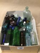 A COLLECTION OF COLOURED GLASS BOTTLES SOME WITH NAMES INCLUDING BOOTS, EIFFEL TOWER, POISON AND
