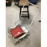 A 1930S DOLLS FOLDING PUSH CHAIR