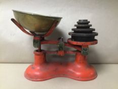 A PAIR OF CAST IRON KITCHEN SCALES WITH WEIGHTS