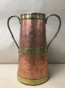 AN ARTS AND CRAFTS BRASS AND COPPER TWO HANDLE PAIL 28CMS